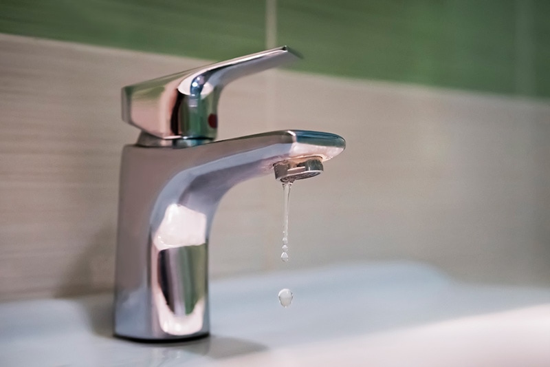 Leaky faucet in a bathroom.